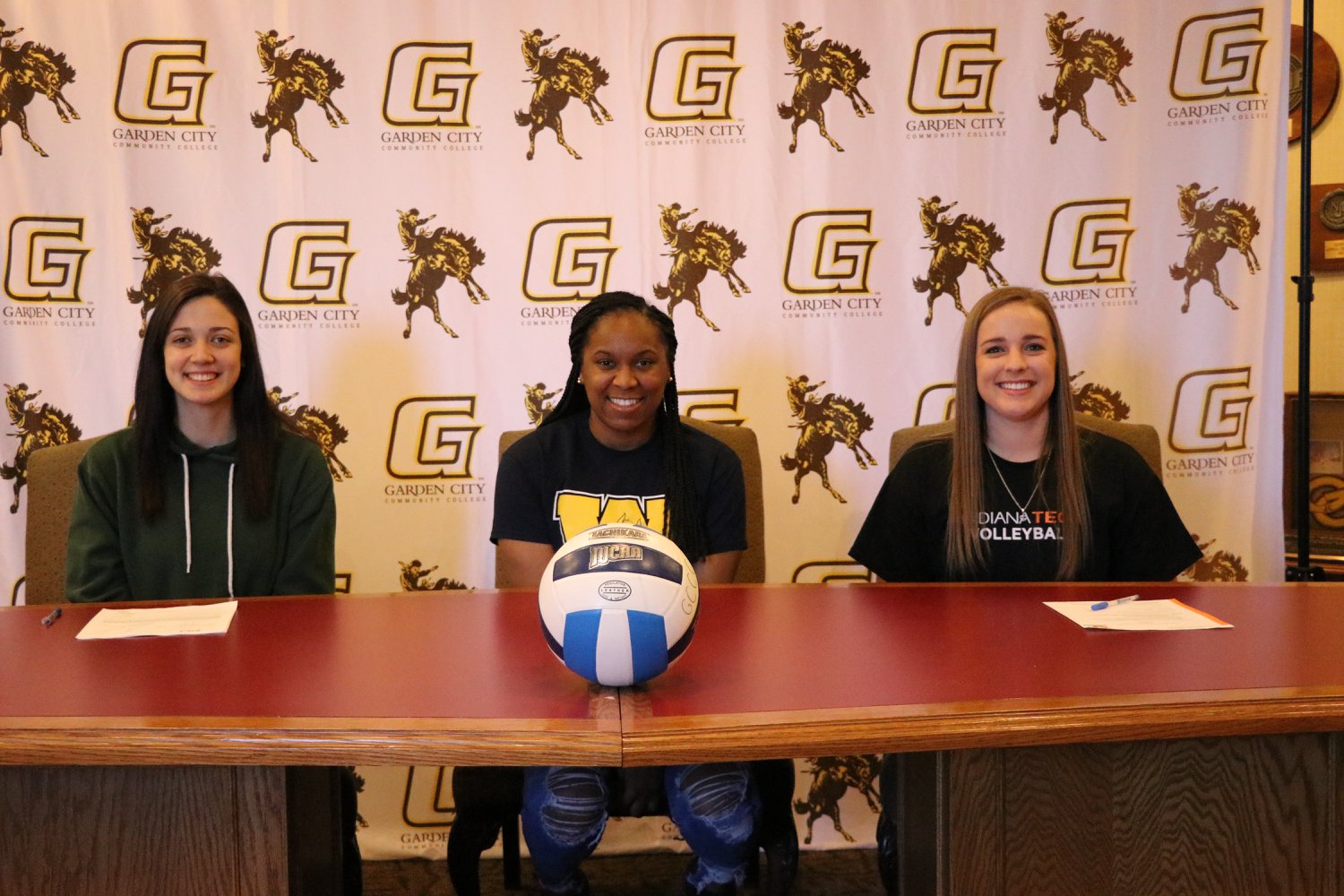 Three volleyball players sign