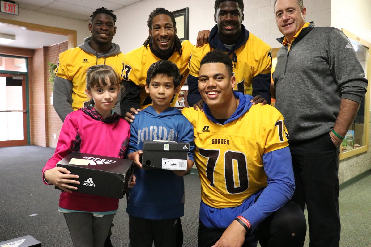 In the community: Broncbuster football players giving shoes to local students